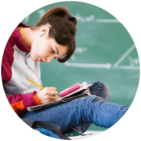 A student reads a book in a classroom.