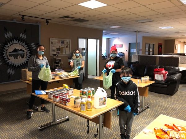 Indigenous community packing food for Covid-19 relief efforts