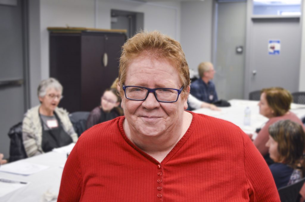 A photo of Brenda at a seniors painting session.