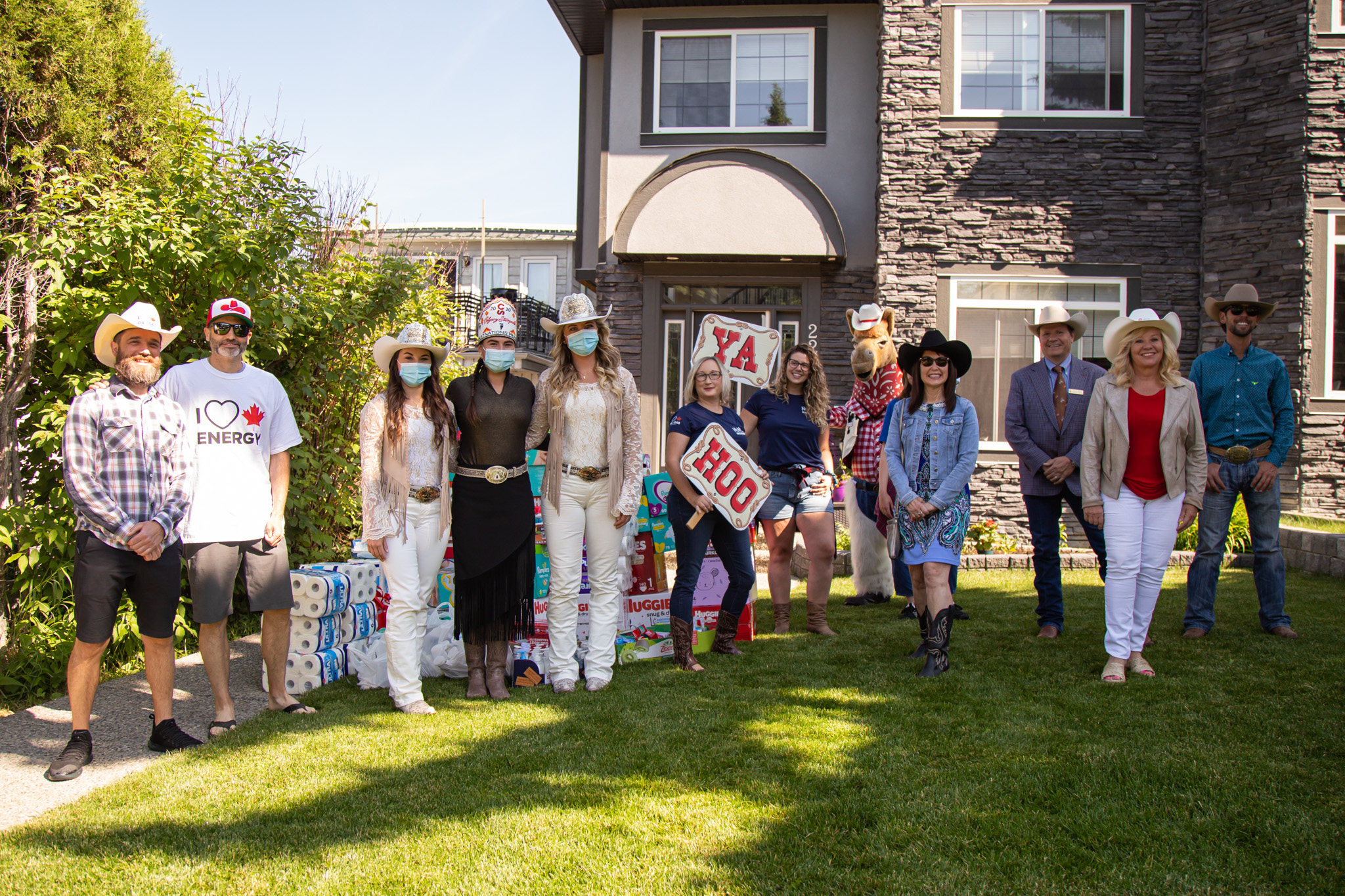 Group shot of individuals with Ya Hoo signs at a donation pick up spot