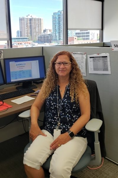Anita sitting at workstation in Calgary downtown office