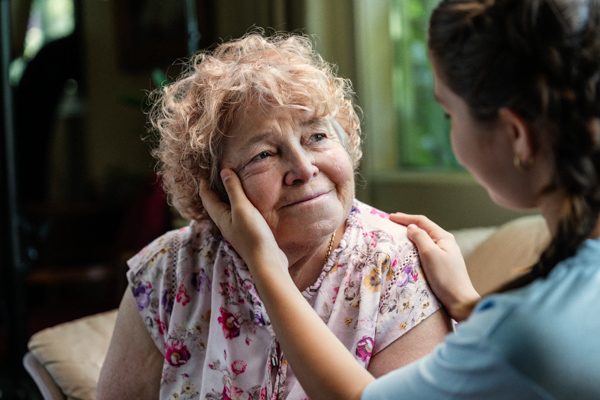 A woman comforts an elderly woman